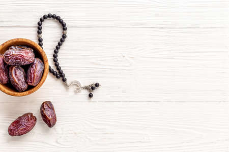 Ramadan concept. Black islamic rosary with crescent with dates fruitsの写真素材