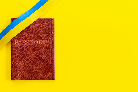 Yellow and blue ribbon with passport. Ukrainian immigration concept