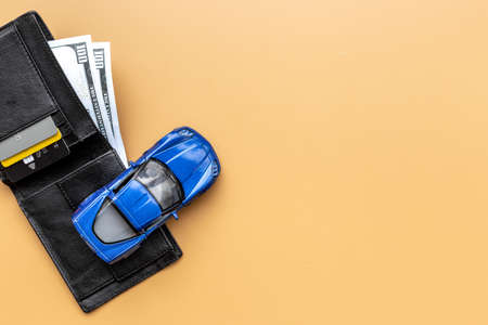 Purchase or rent a car concept. Toy car with wallet and money cashの写真素材