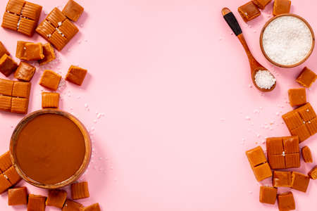 Bowl of caramel sauce and toffee candies with sea salt, top viewの写真素材