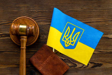 Ukrainian refugees concept. Flag with passport and gavelの写真素材