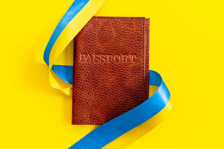 Ukrainian immigration concept - yellow and blue ribbon on passportの写真素材