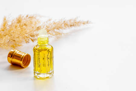Arabic perfume Oud oil in glass bottle, close up. Aromatic Arabian oil