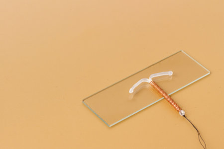 T-shaped copper contraceptive on medical glass. Hormone free contraception conceptの写真素材