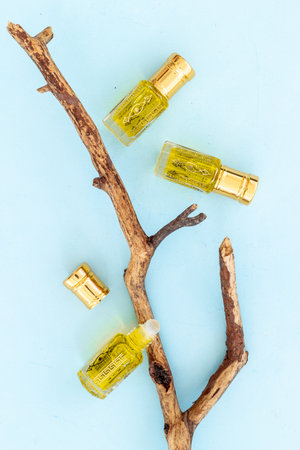 Arabian oud attar perfume essential oil in glass bottles, top view