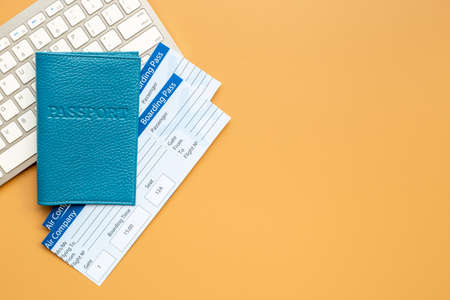 Booking tickets online - passport with air tickets on keyboard