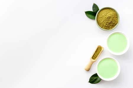 Green hot tea in bowls with matcha powder, top viewの写真素材