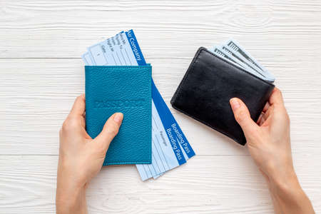 Hand holding passport with air tickets. Vacation tourism concept