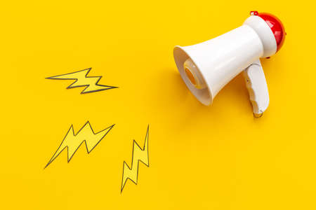 White megaphone with flying lightning. Hot news or advertising conceptの写真素材