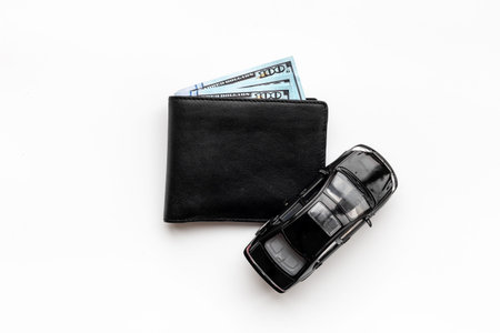 Toy car with wallet and money. Purchase a car concept
