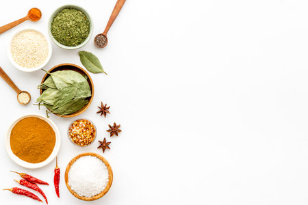 Set of colorful spices and herbs in bowls, top view