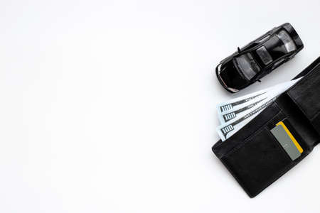 Toy car with wallet and money. Purchase a car conceptの写真素材