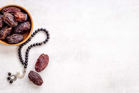 Ramadan concept. Black islamic rosary with crescent with dates fruitsの写真素材