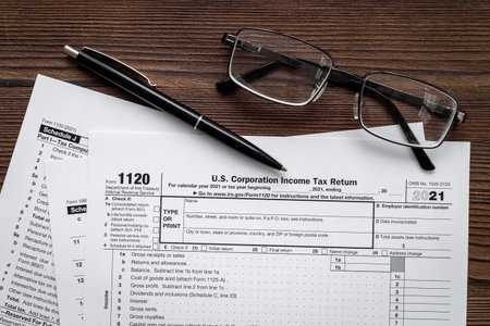 Businessman table with US tax form and pen. Culculating and payment of taxesの写真素材