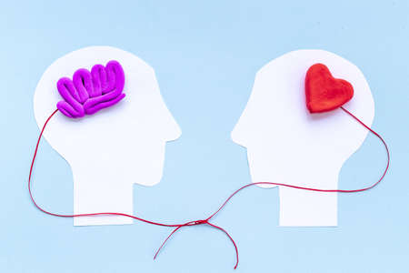 Brain and heart - logic and emotion. Communication between two paper human heads