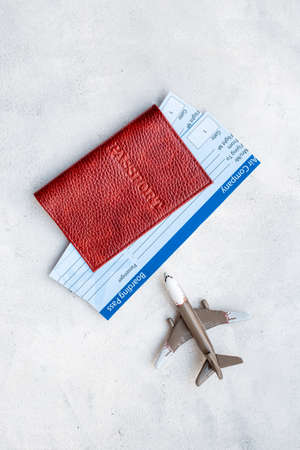 Immigration ot travel concept with tickets in passport and airplaneの写真素材