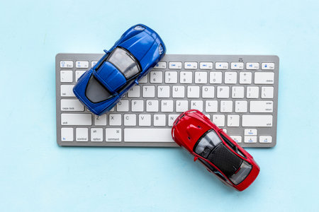 Buy or rent a car concept. Toy car near computer keyboard