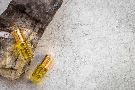 Arabian oud attar perfume essential oil in glass bottles, top viewの写真素材