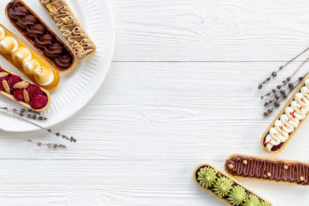 Sweet bakery eclairs with creamy decor, top viewの写真素材