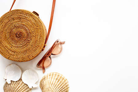 Summer rattan bag with beach accessories. Beach flatlay backgroundの写真素材
