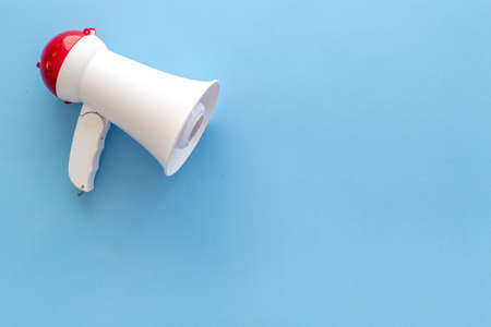 White megaphone against the empty wall. Hiring or advertising conceptの写真素材