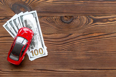 Saving money to buy a car. Toy car with money cashの写真素材