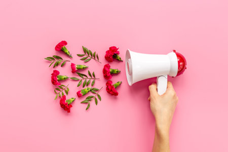 Megaphote in hand with flying flowers and leaves. Hiring or advertising concept