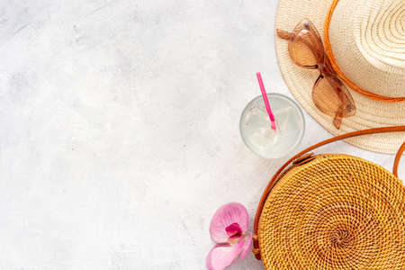 Beach bag with straw hat. Summer beach background, flatlay