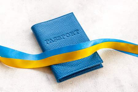 Yellow and blue ribbon with passport. Ukrainian immigration concept