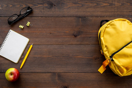 Students supplies in yellow school backpack. Back to school conceptの写真素材