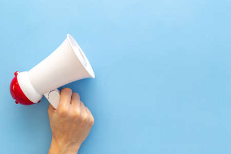 Attention concept. Hand holding megaphone for announcing hot news or advertisingの写真素材