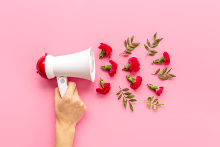 Good news or advertising concept with megaphote and flying flowersの写真素材