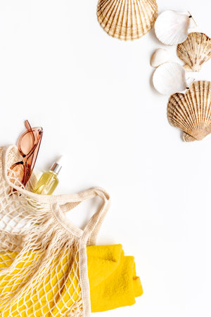 Womans beach accessories - grid string bag with sunglasses and towelの写真素材