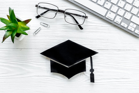 Academic cap or graduation hat on students desk. Education conceptの写真素材