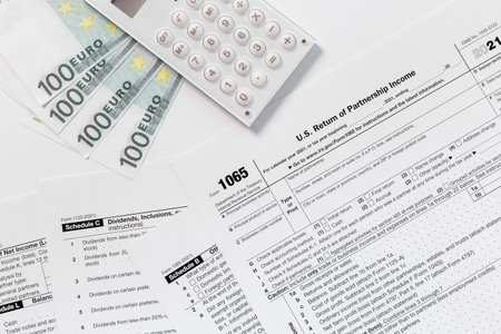 Annual tax form under US law with money cash. Tax payment seasonの写真素材