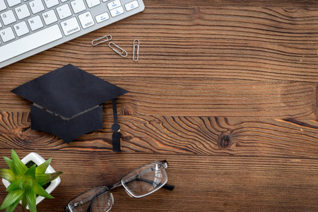Graduation at the university concept. Academic cap on students tableの写真素材