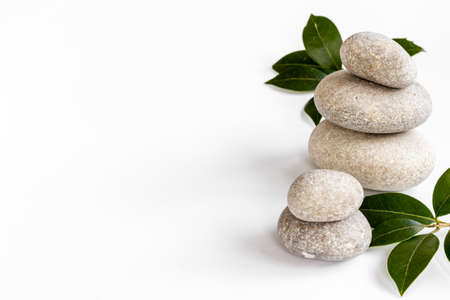 Spa stones for massage with leaves for beauty therapyの写真素材