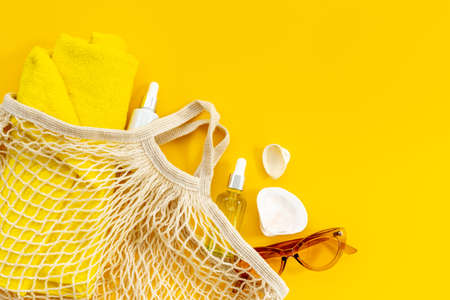Womans beach accessories - grid string bag with sunglasses and towelの写真素材