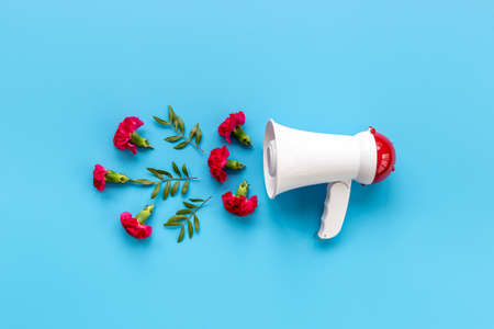 Advertising idea - megaphote with flying flowers and leaves. Good news conceptの写真素材