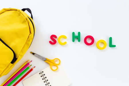 Classic yellow school backpack top view. Educational objects backgroundの写真素材