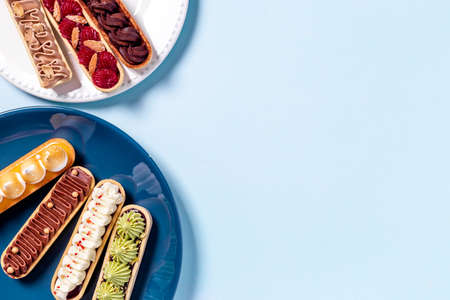 Cupcakes eclairs with pistachio raspberries and chocolate cream toppingの写真素材