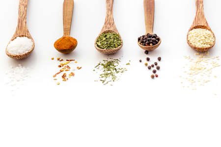 Powdered spices and herbs in wooden spoons. Colorful cooking backgroundの写真素材