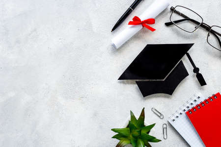 Students desk with graduation hat and diplima. Education conceptの写真素材