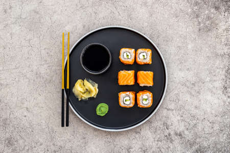 Salmon sushi rolls set on plate, top view. Japanese cuisineの写真素材