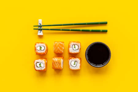 Sushi rolls set with salmon flatlay on table, top view