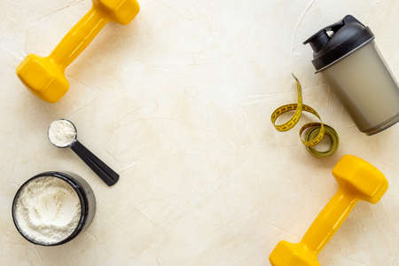 Sport bottle and jar of powder whey protein and dumbbells. Fitness and gym dietの写真素材