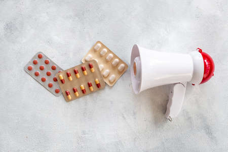 White megaphone with pills and drags. Health care conceptの写真素材