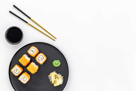 Japanese cuisine. Salmon sushi rolls set on plate, top viewの写真素材