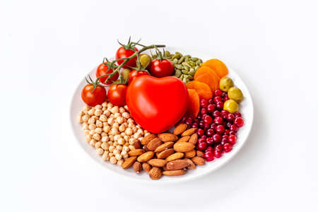 Healthy diet eating concept. Less fat more omega 3 food in plate with heart objectの写真素材