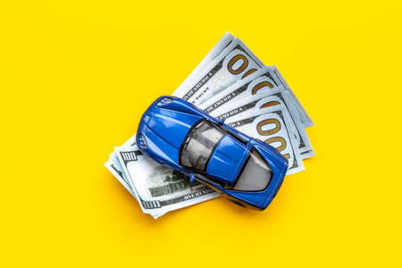 Saving money to buy a car. Toy car with money cashの写真素材